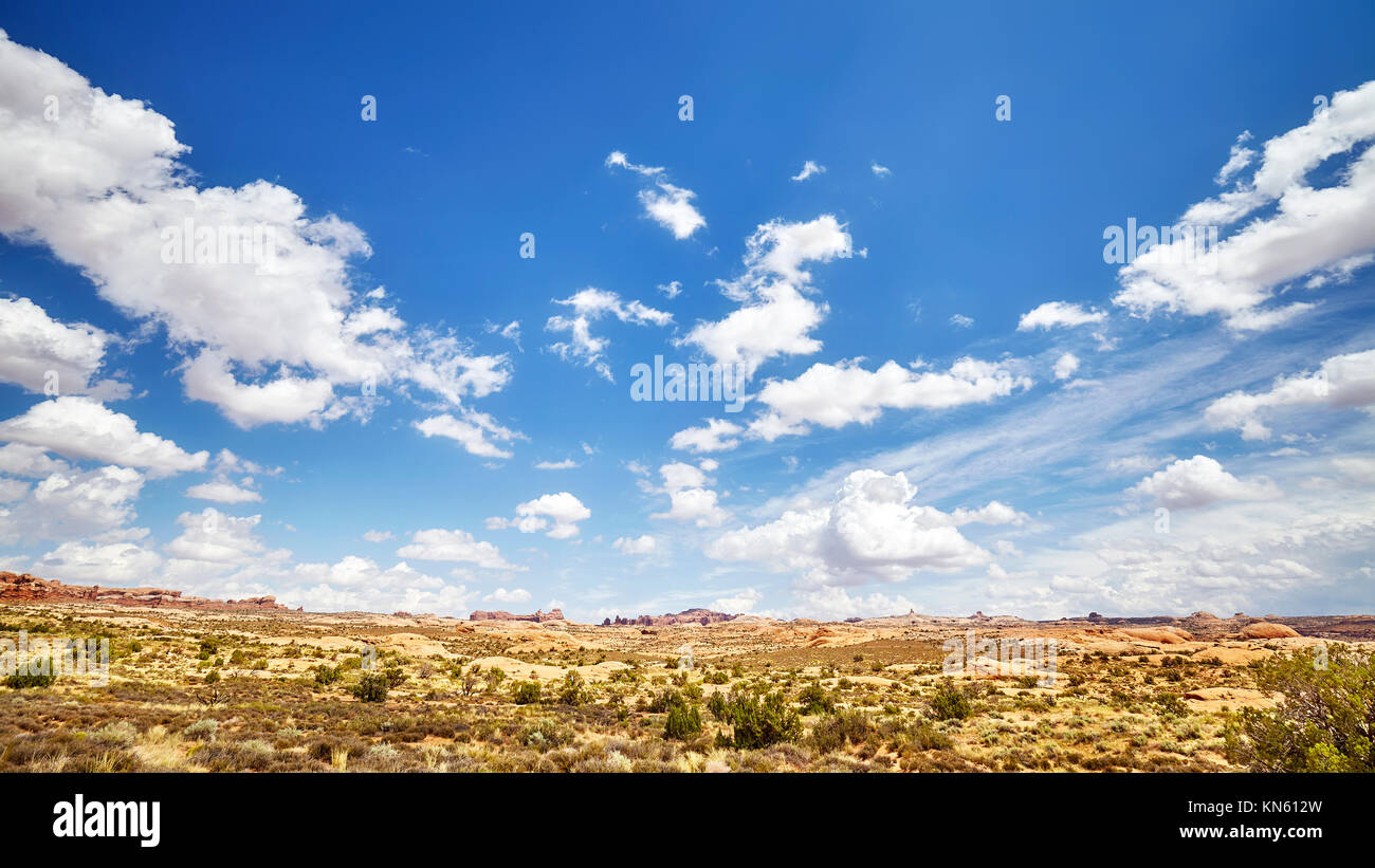 Vast deserted landscape with beautiful cloudscape on the blue sky. Stock Photo