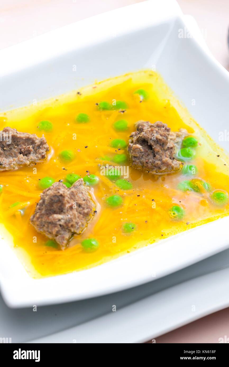 homemade liver dumplings in chicken soup with carrots and peas Stock