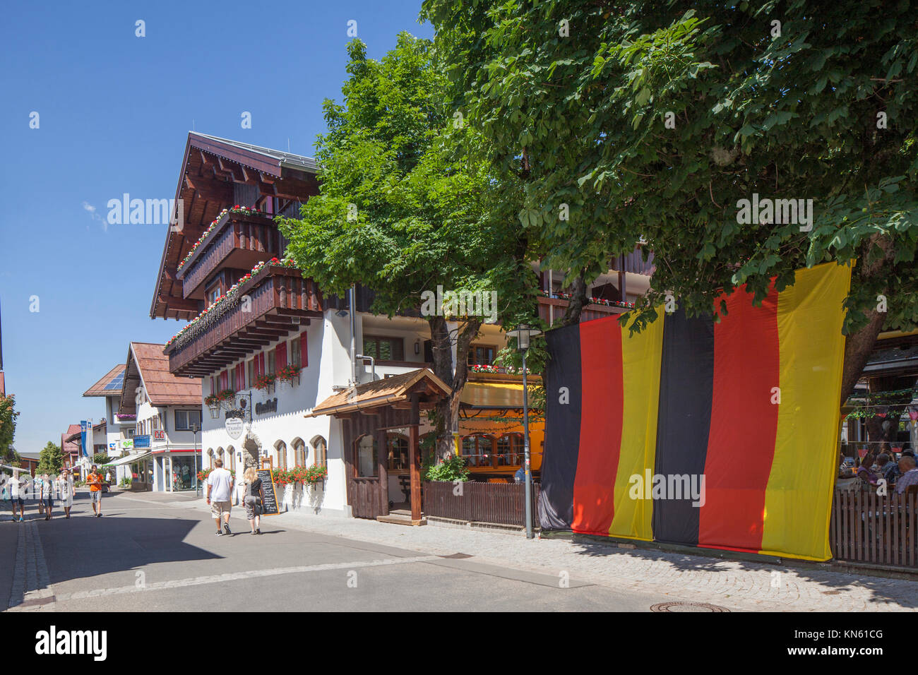 Houses in Kirchstraße Street and German Flag on a Wall, Oberstdorf, Oberallgäu, Allgäu, Swabia, Bavaria, Germany, Europe I Häuser mit Deutschlandflala Stock Photo