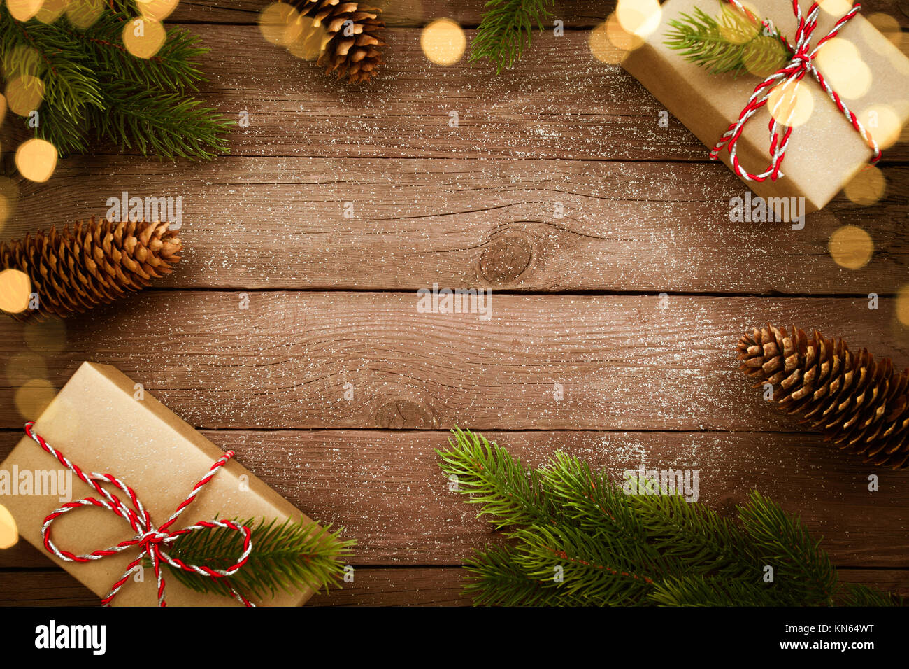 Christmas presents in kraft box on vintage wooden table with decorations. Top view Stock Photo