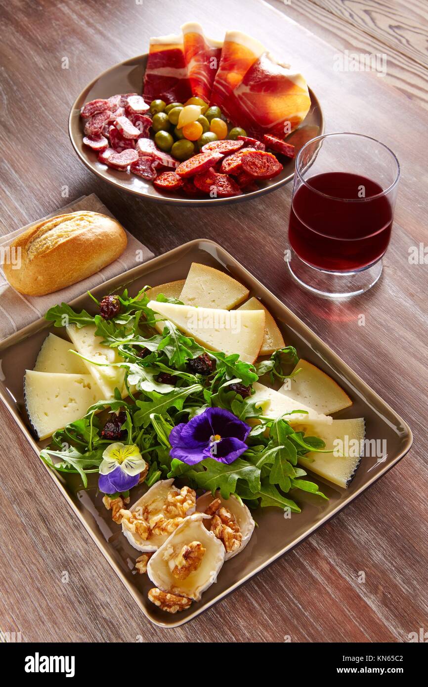 Spain food tapas ham sausage and salad with cheese honey and nuts Stock