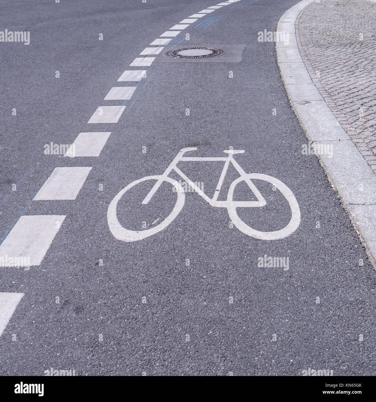 bicycle sign on asphalt in a city. Stock Photo
