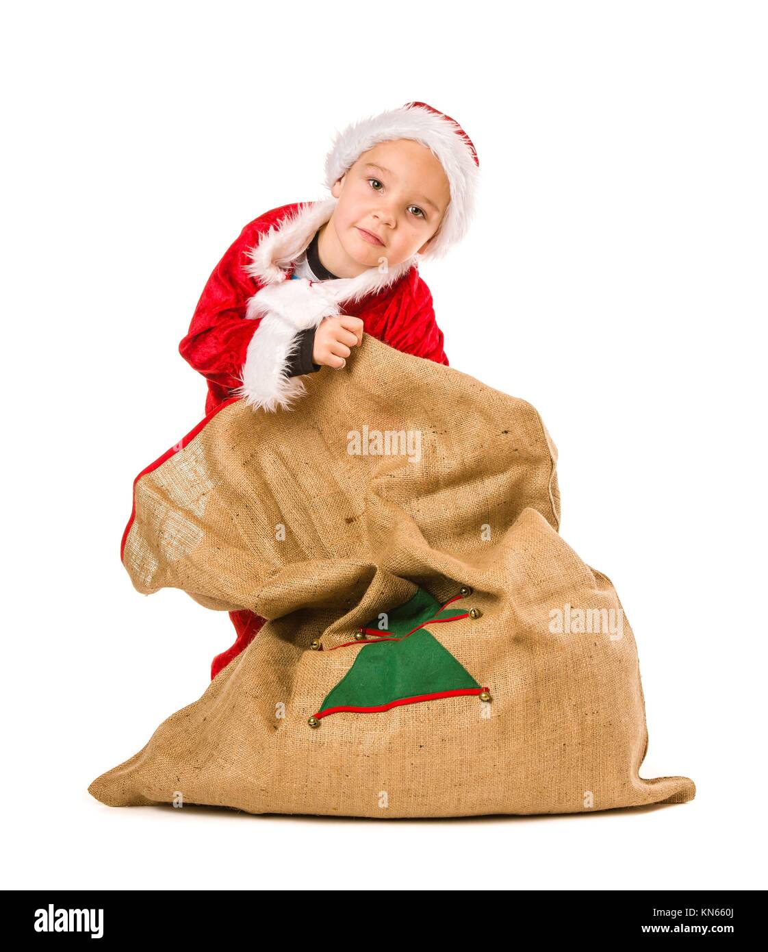 Adorable 5 year old boy wearing Santa Claus costume, Christmas sack