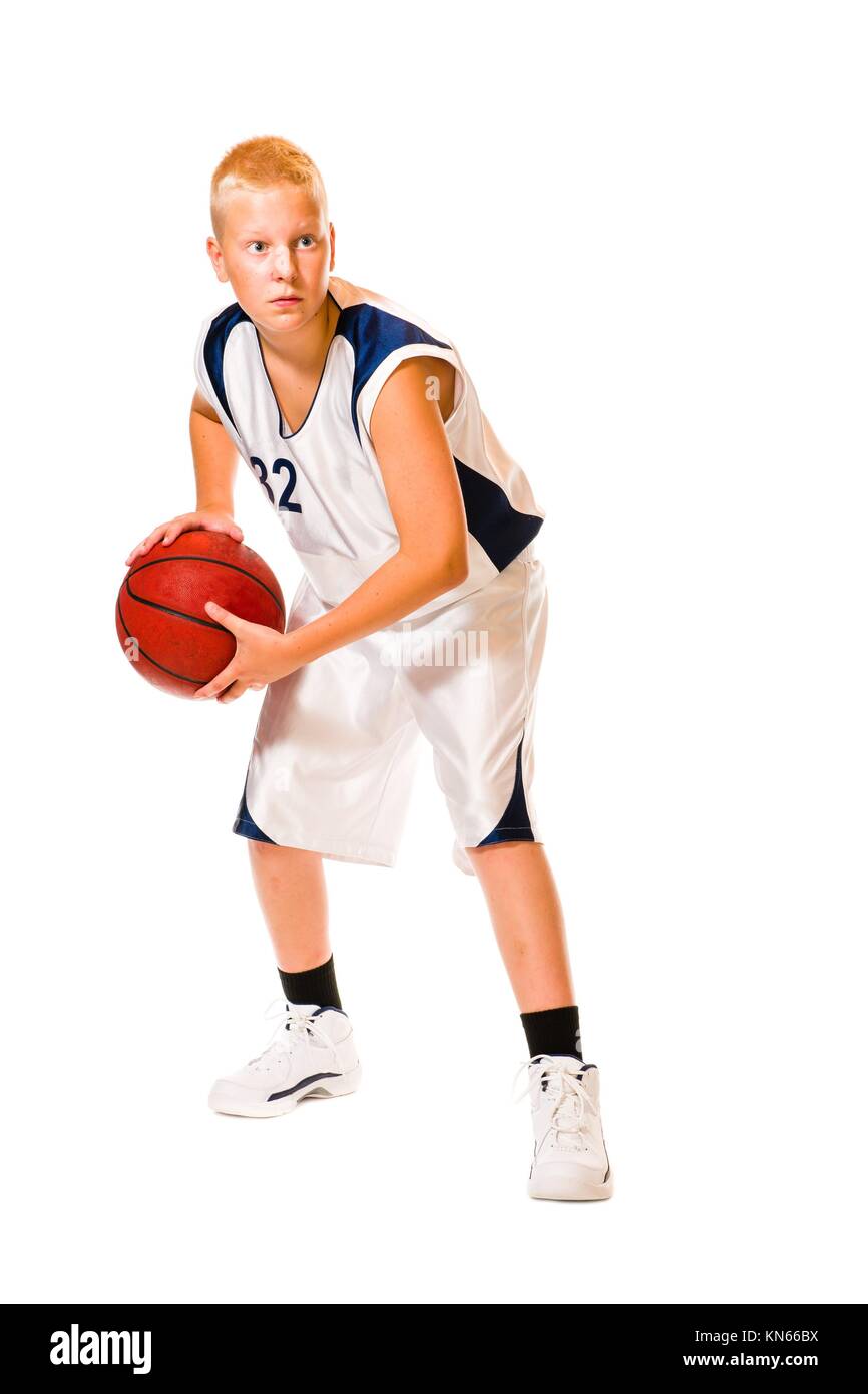 Young basketball player wearing white team uniform, studio shot, white