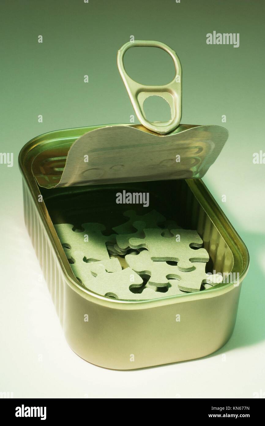 Jigsaw puzzles in tin can Stock Photo Alamy