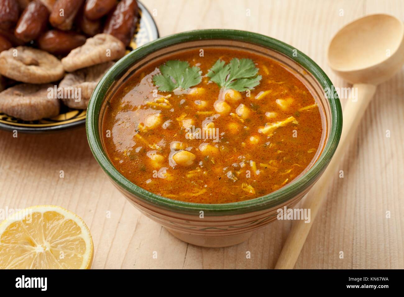 Bowl of Moroccan harira soup, lemon, dates and figs for iftar. Stock Photo