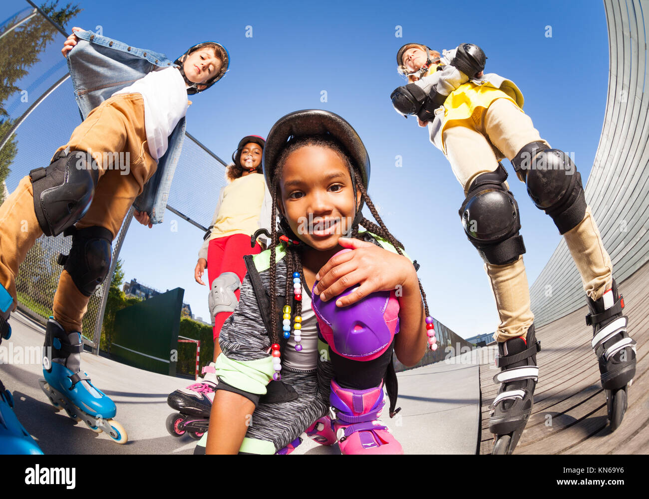 Portrait of African girl in roller skates, helmet, elbow and knee pads