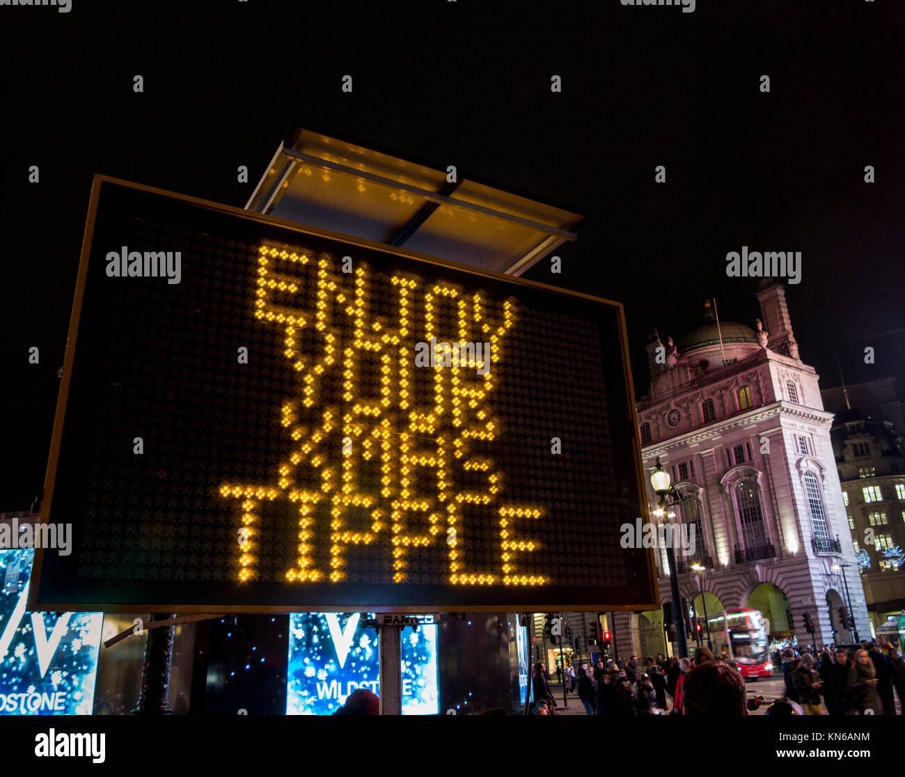 Police sign at Piccadilly Circus warning of thieves in the area as well as to Enjoy your Xmas Tipple but Know Your Limits and watch out for your phone Stock Photo