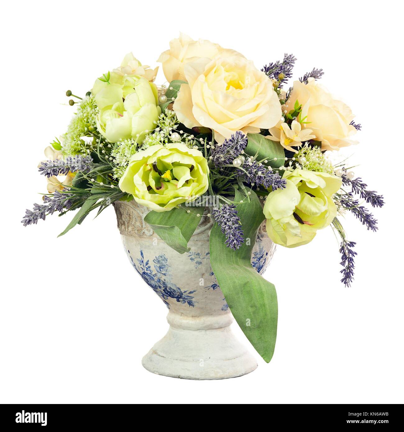 Bouquet from artificial flowers arrangement centerpiece in old vase isolated on white background. Stock Photo