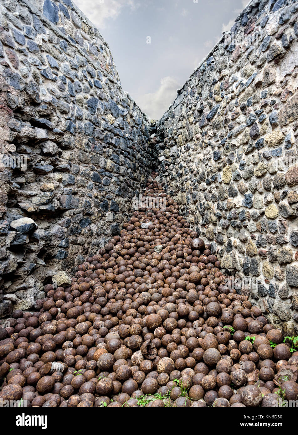 A pile of medieval rusted iron projectiles forming a superb perspective in a castle corner Stock Photo