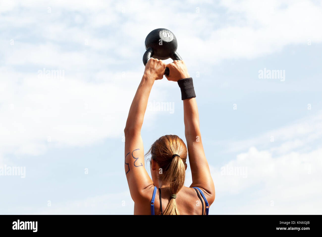 Young woman doing kettlebell swings at crossfit competition Stock Photo Alamy