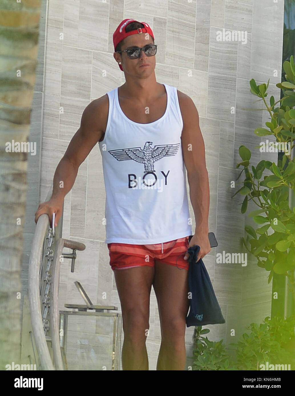 MIAMI BEACH FL JUNE 24 Cristiano Ronaldo seen in south beach wearing red shorts a shirt thats says BOY and a matching red hat thats says SWAGGER Cristiano Ronaldo dos