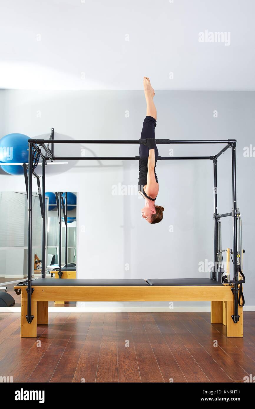 Pilates woman in cadillac acrobatic upside down balance reformer exercise  at gym Stock Photo - Alamy