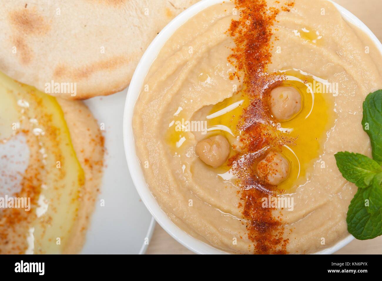traditional chickpeas Hummus with pita bread and paprika on top Stock