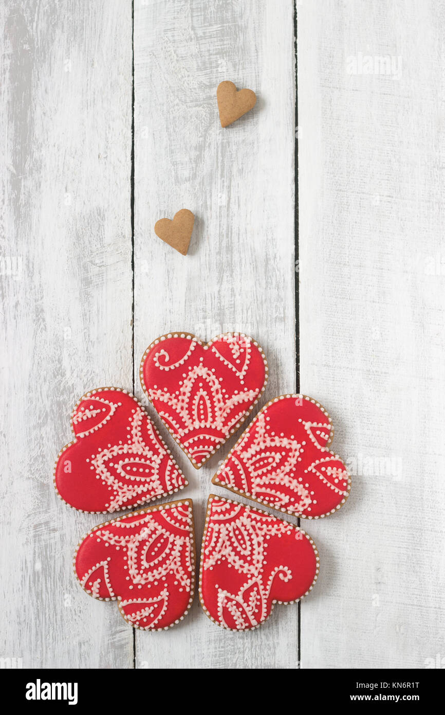 Red gingerbread heart on a white wooden background. Stock Photo
