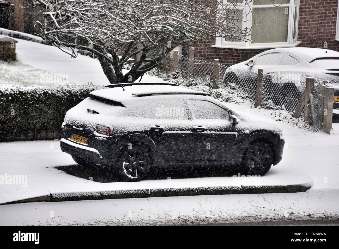 A car parked on the side of the road with alight dusting of snow Stock ...