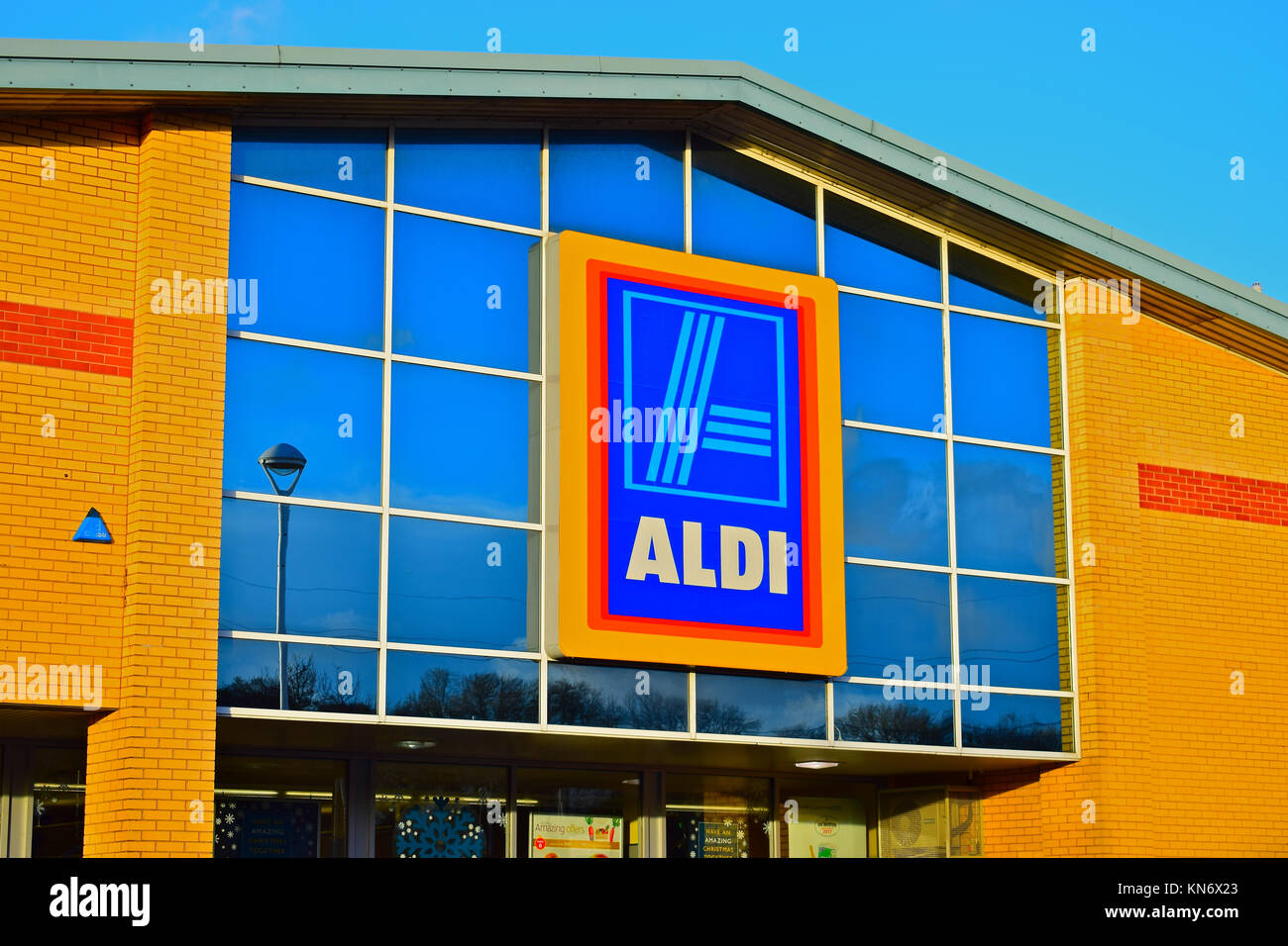 The logo and store sign of the Aldi supermarket in Talbot Green. Warm ...