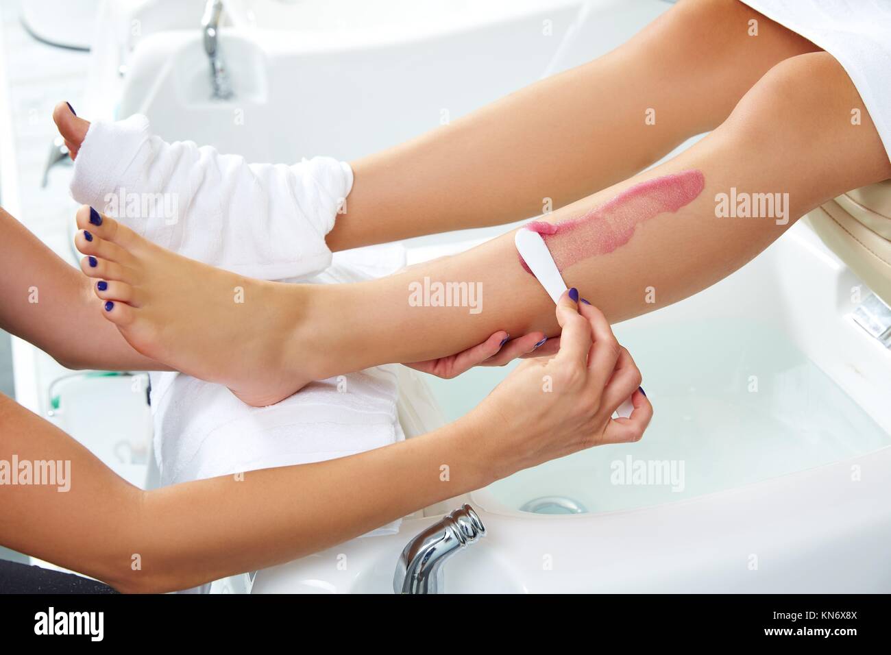 foot scrub pedicure woman leg in nail salon on chair sofa Stock Photo