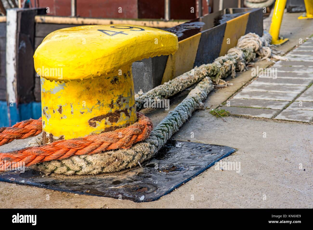 Bollard with mooring lines Stock Photo Alamy