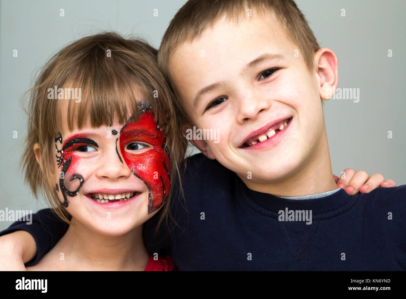 beautiful little girl with a painted fox on her face. face painting Stock  Photo