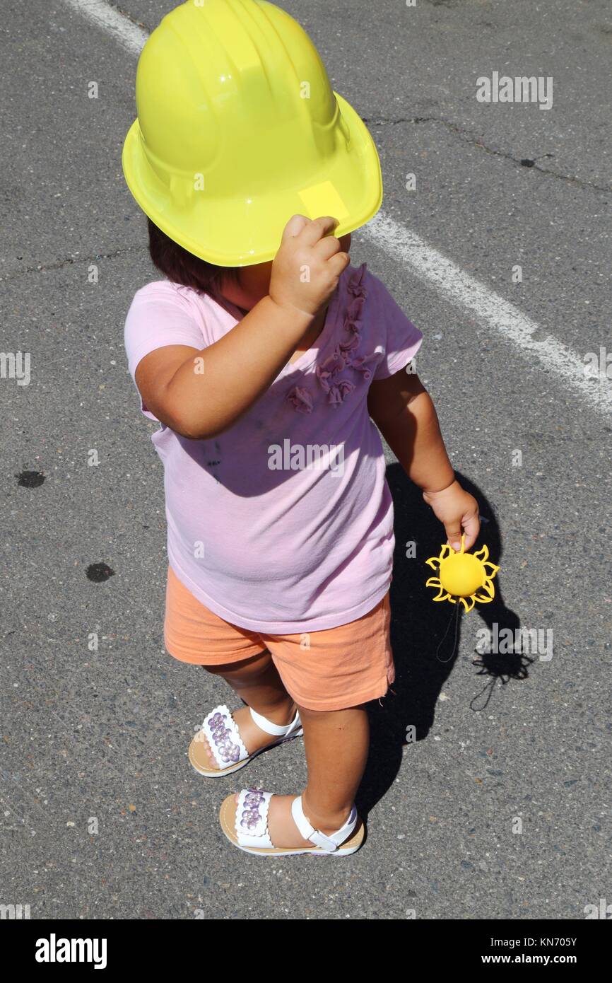 Kid with yellow helmet looking sidewards. Stock Photo