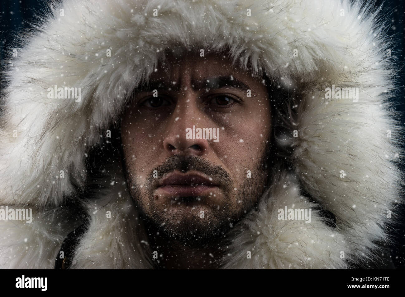 Close up portrait of a white man dressed with an eskimo jacket in the snow  Stock Photo - Alamy