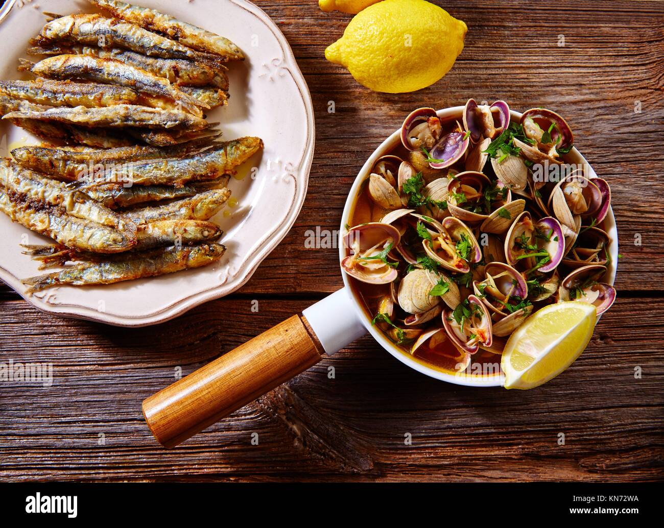 Tapas spanish seafood clams shrimps calamari romana and fried anchovies fish. Stock Photo