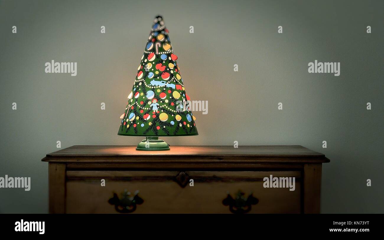 An antique Christmas tree lamp spins from the heat given off by the