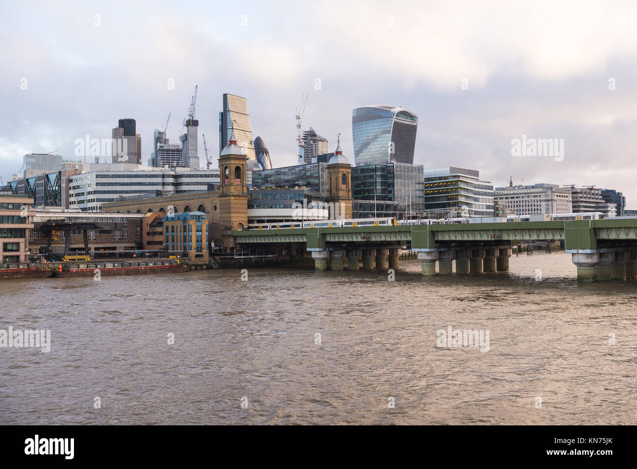 Easterly view across the River Thames of the City of London and Southwark bridge, as seen from the Millenium Bridge, London, England, UK. Stock Photo