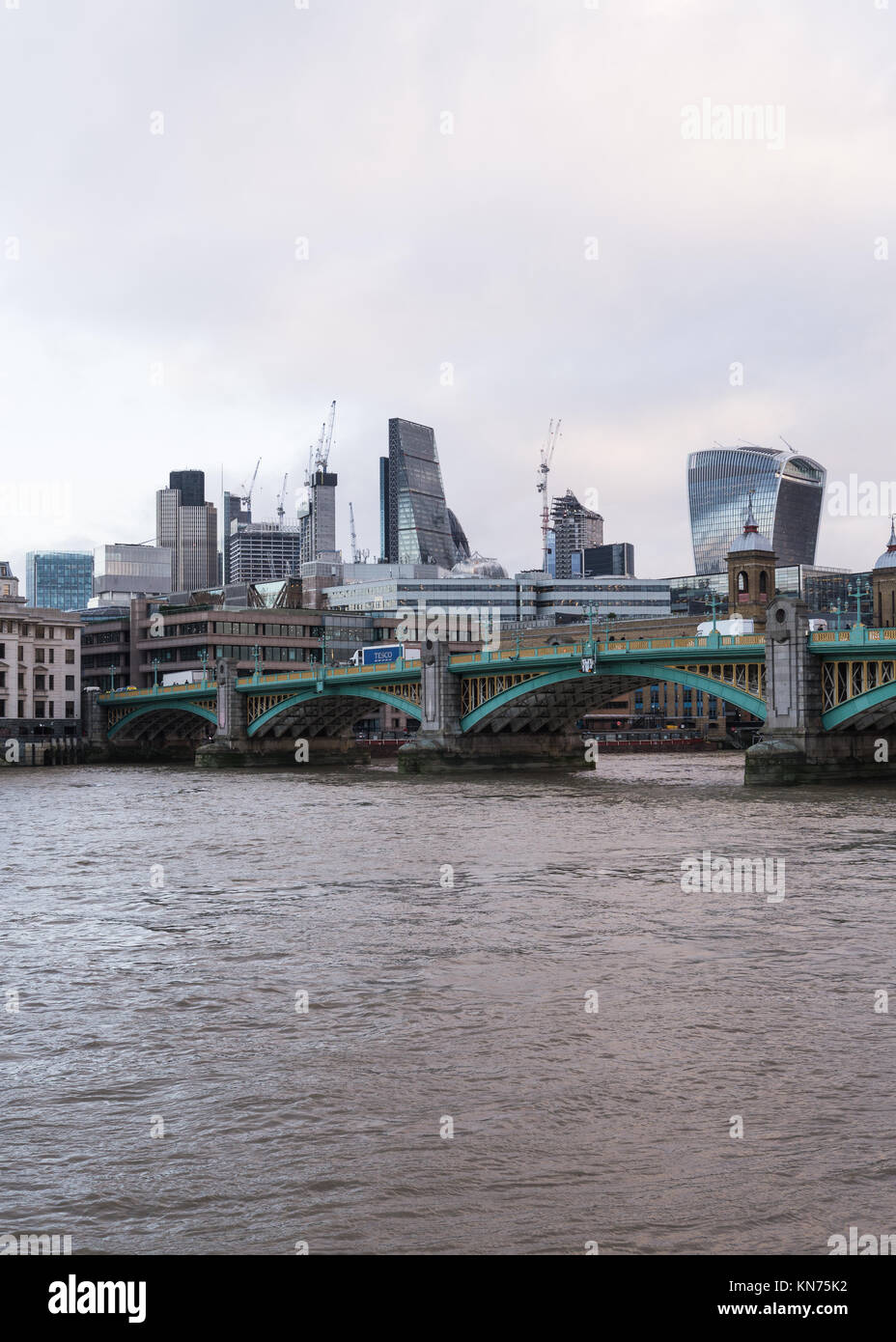 Easterly view across the River Thames of the City of London and Southwark bridge, as seen from the Millenium Bridge, London, England, UK. Stock Photo