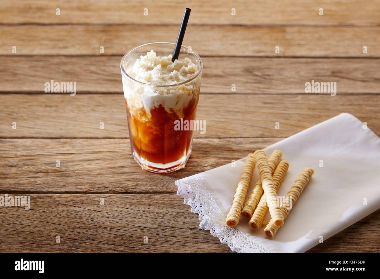 Coffee smoothie with wafers on vintage wood table. Stock Photo