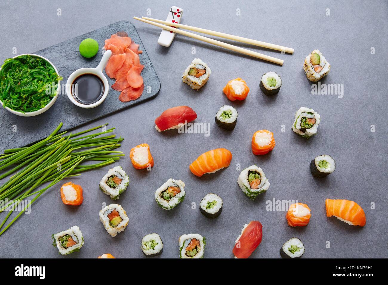 Sushi ingredients, nori seaweed on makisu bamboo mat for rolling, fresh raw  salmon, raw sushi rice, soy sauce and chopsticks on the side Stock Photo -  Alamy