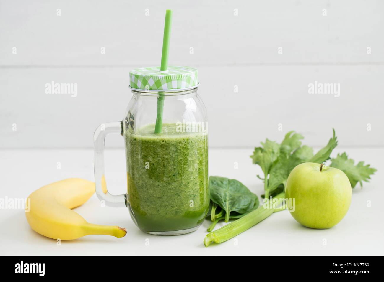 Healthy green smoothie made of banana, apple, spinach and celery in a