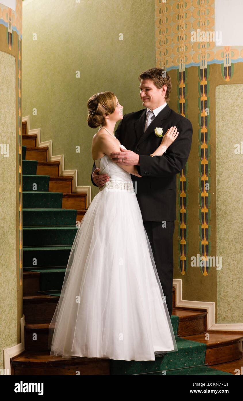 Bride And Groom Are Standing Together On The Steps Stock Photo - Alamy