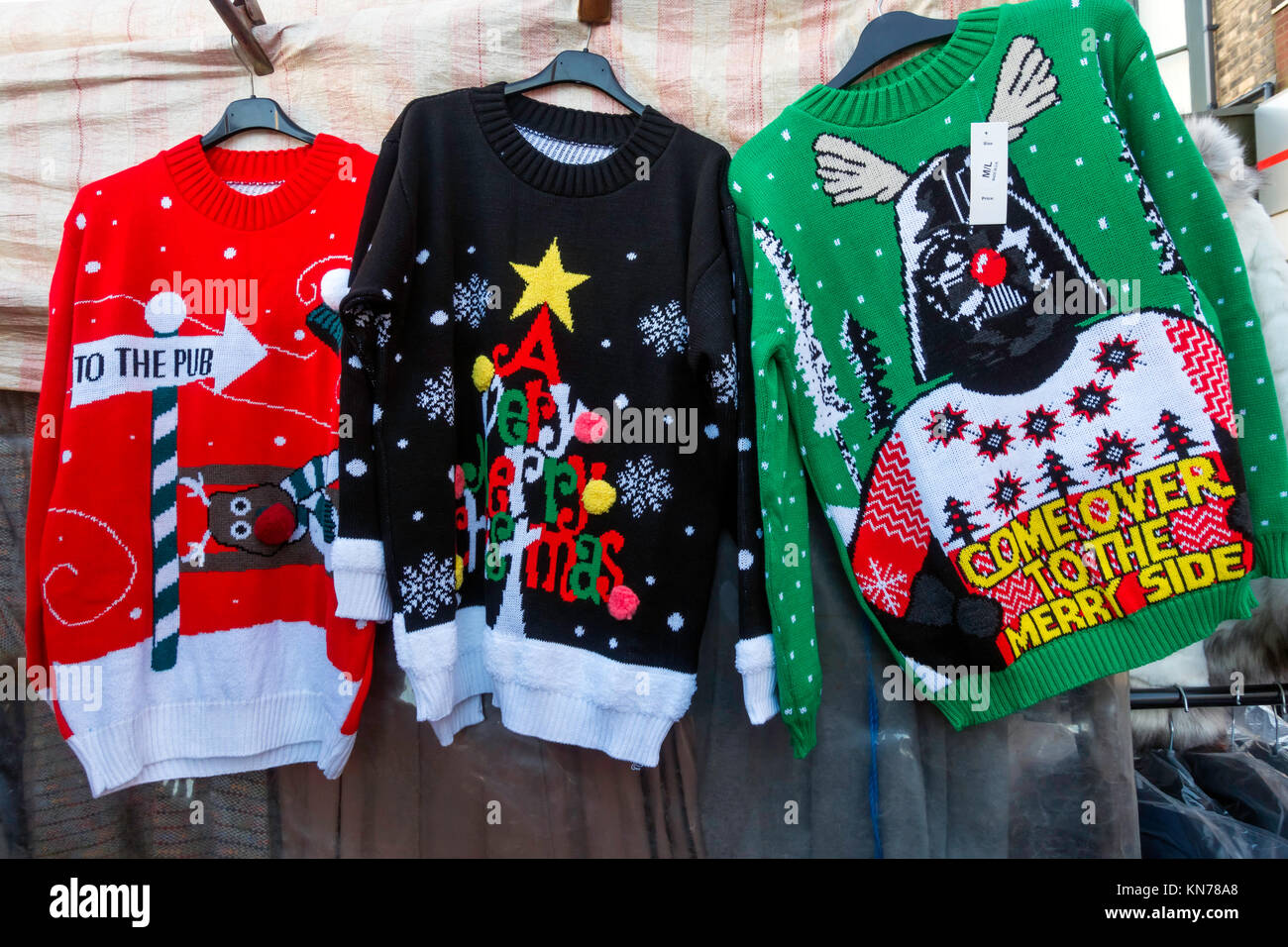 Market stall Christmas novelty sale  knitted jumpers with pub and reindeer patterns Stock Photo