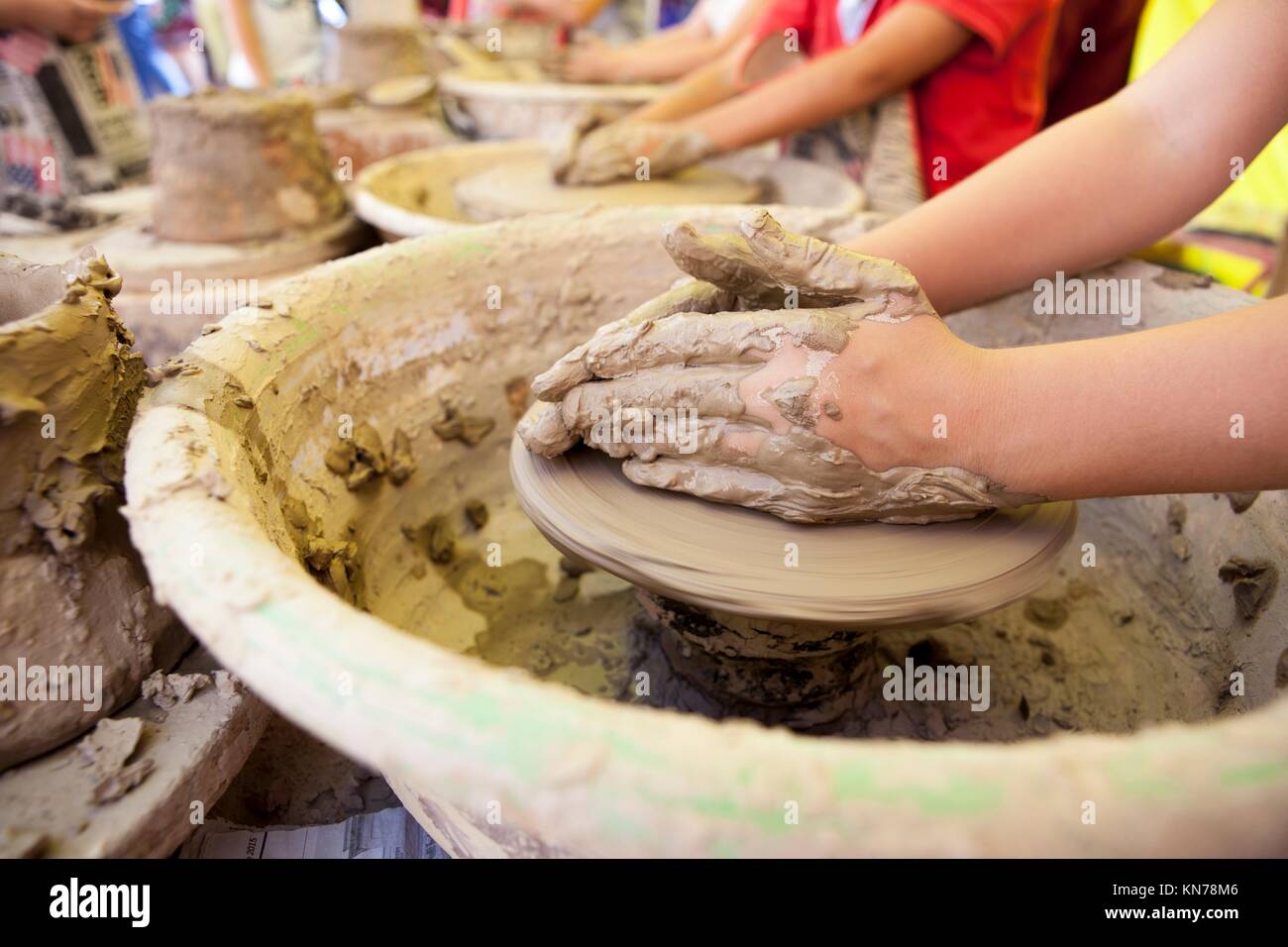 Children learning to work with potter's wheel Stock Photo Alamy