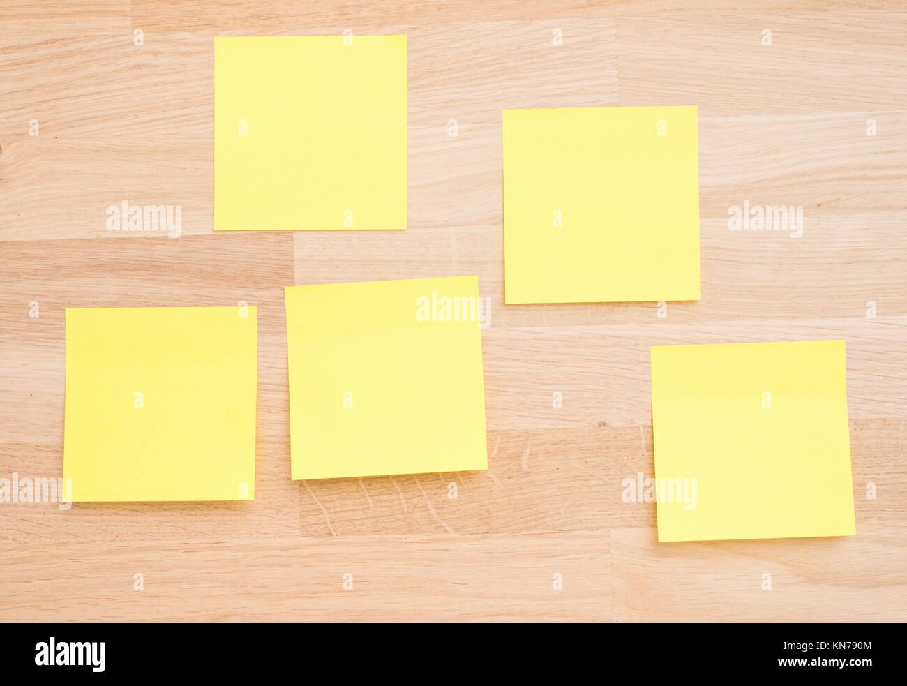 Empty sticky notes on wooden table. Office desktop background with copy  space Stock Photo - Alamy