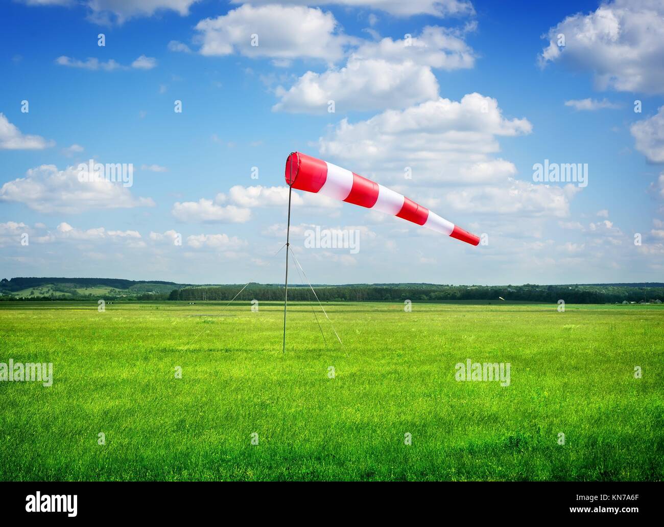 Air field direction sign and a wind force against the dark blue sky. Stock Photo