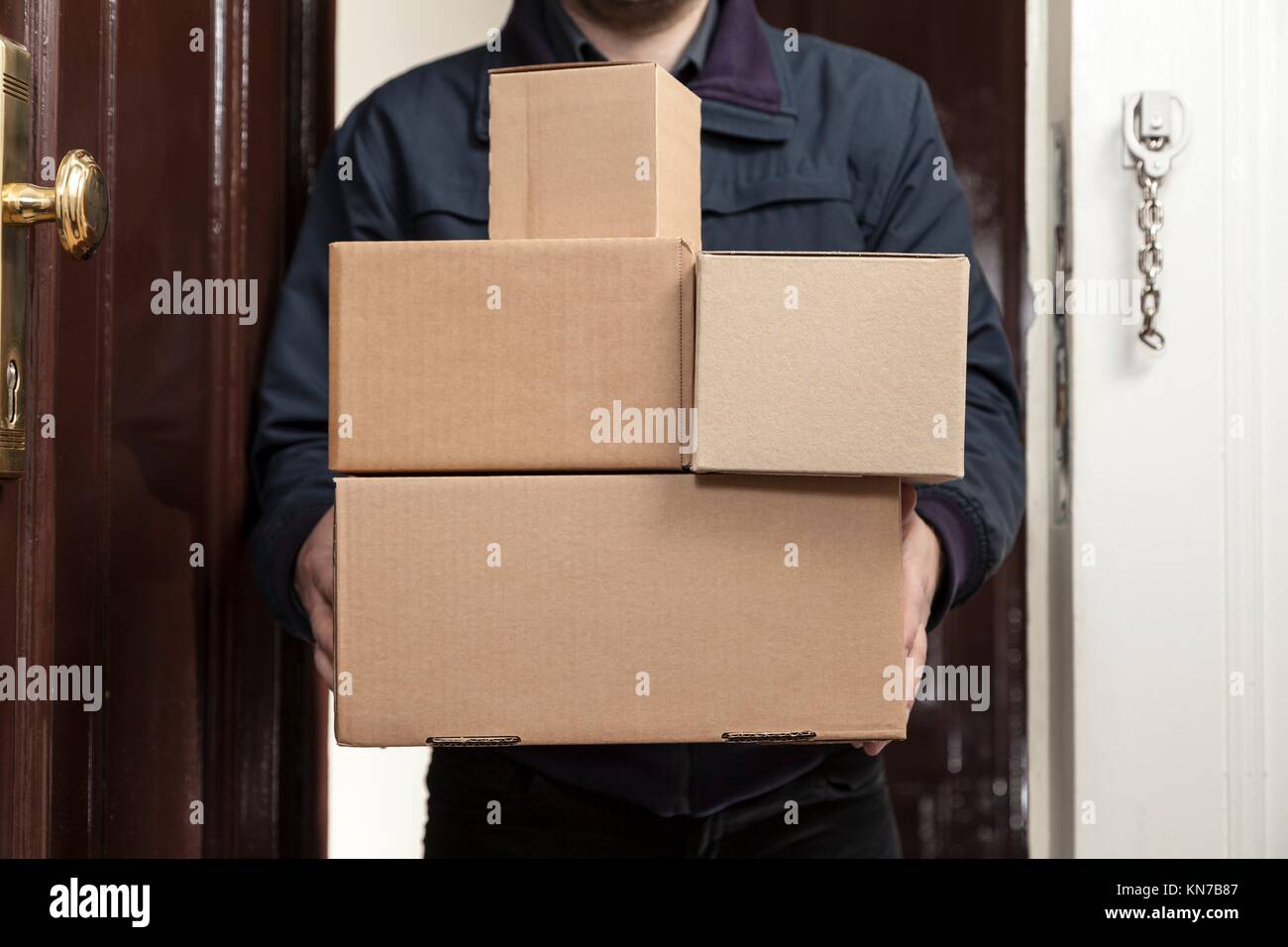 Postman brings a lot packages. Stock Photo