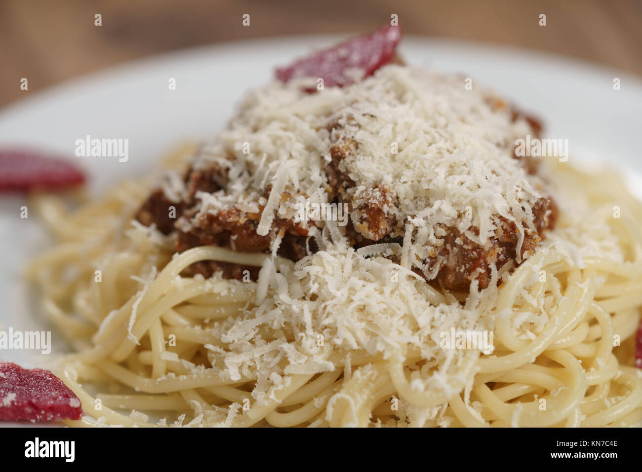 spaghetti bolognese with fuet sausage on wood table Stock Photo - Alamy