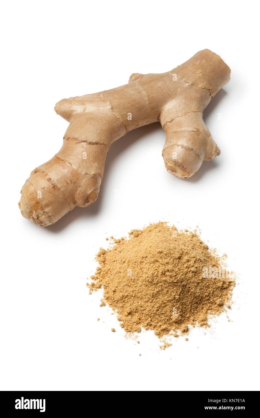Fresh ginger rhizome and a heap of ground ginger on white background. Stock Photo