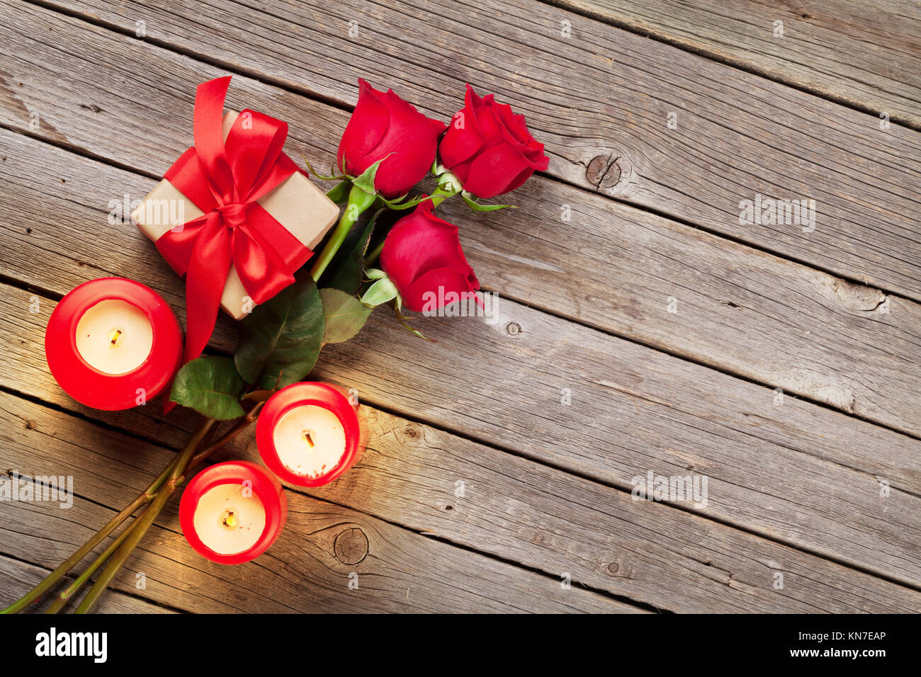Valentines day greeting card, red rose flowers, candles and gift box on ...