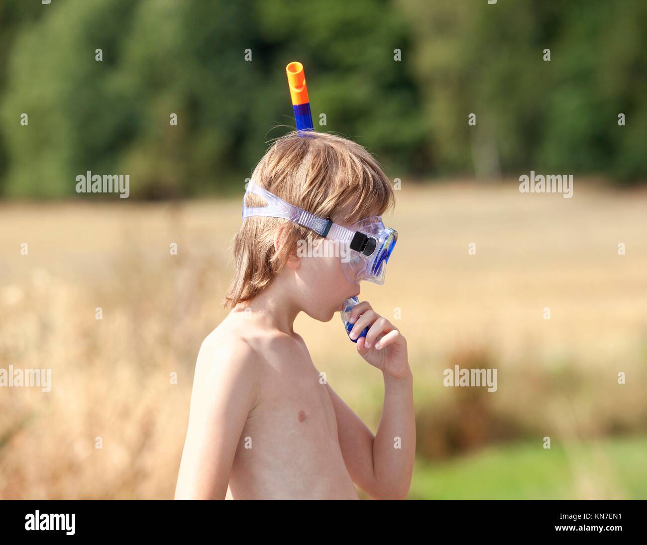 Boy Fitting in Breathing Tube before Snorkeling. Stock Photo