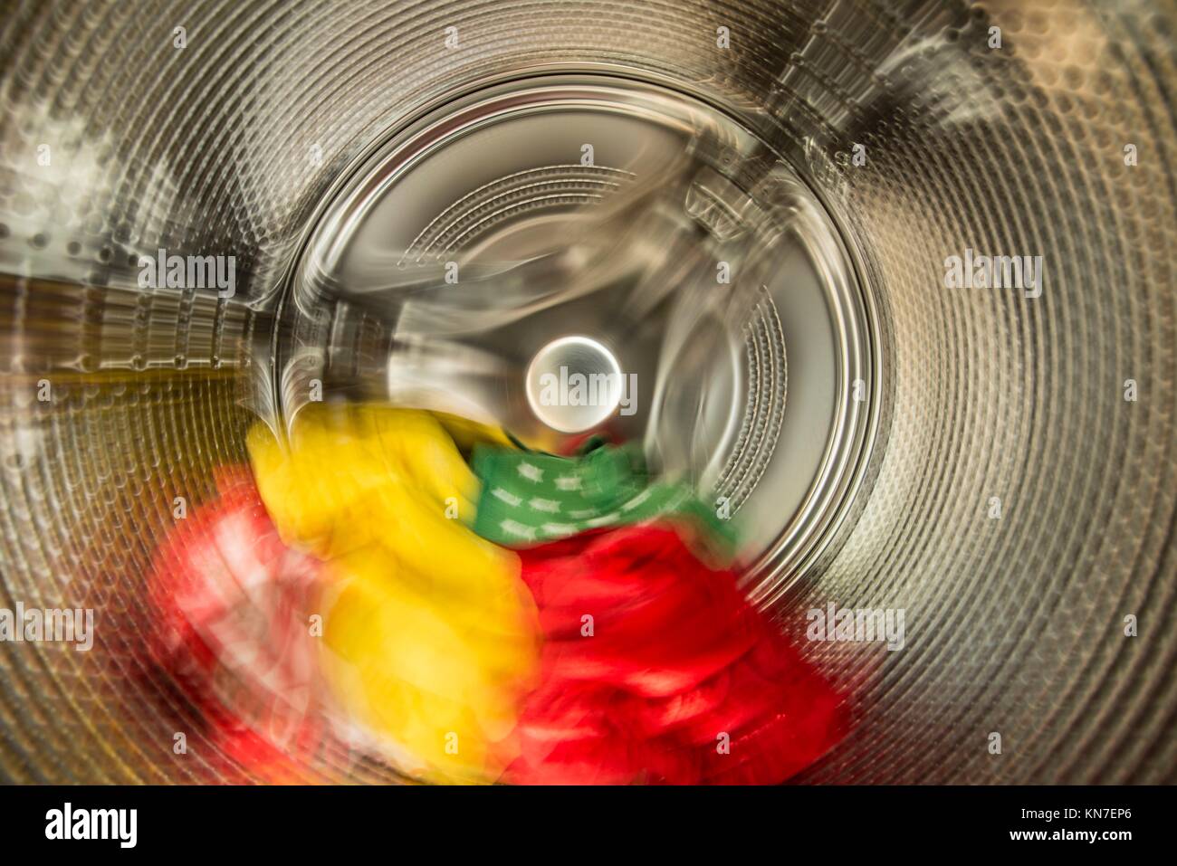 Interior view of washer. Blurred motion of laundry spinning around in