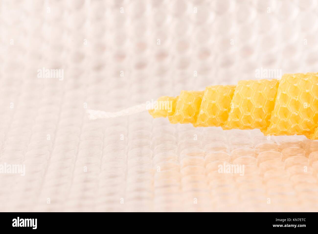 Close up of yellow bees-wax candle. Organic handicraft object. Stock Photo