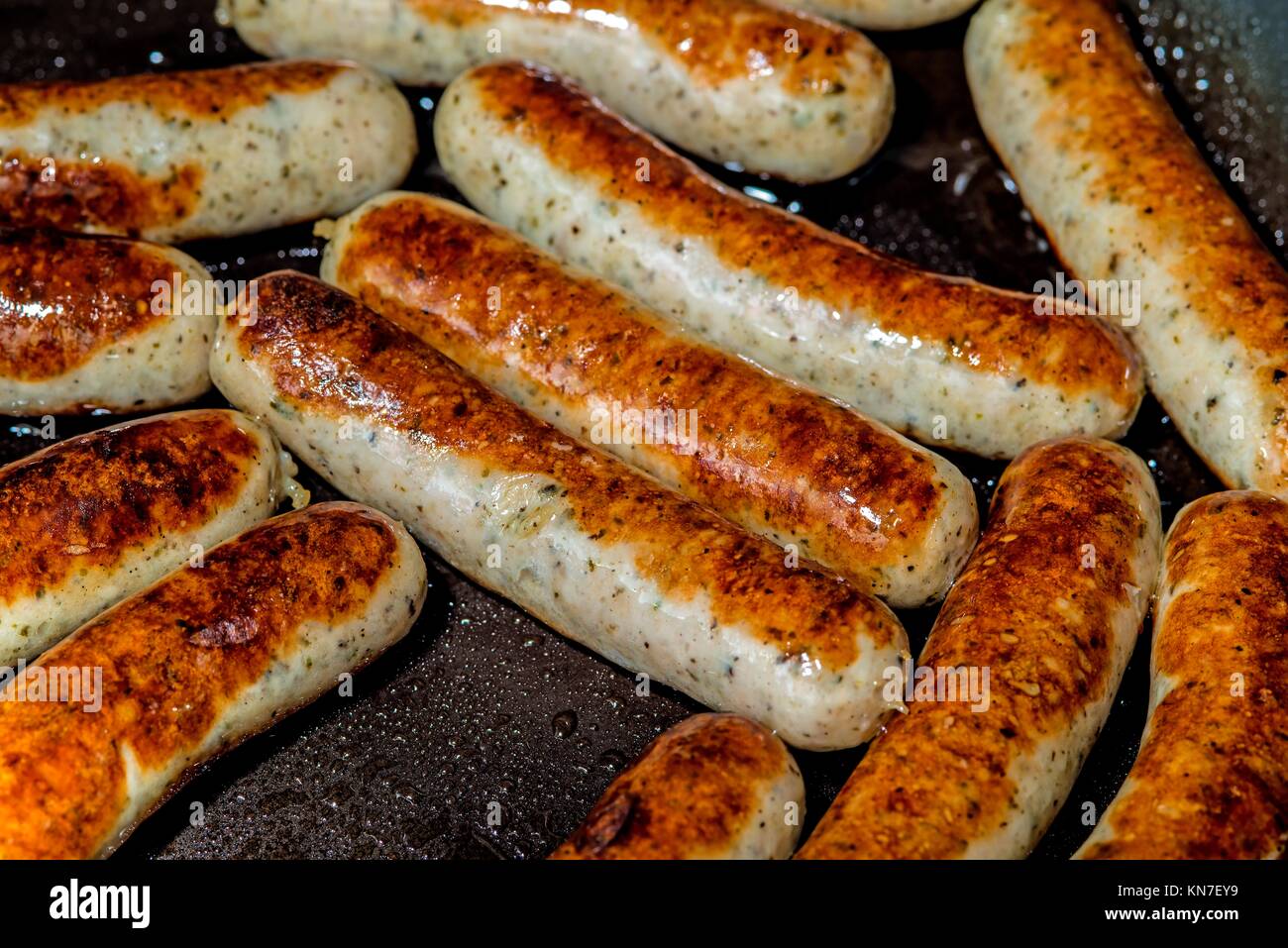 crispy sausages in a pan Stock Photo Alamy