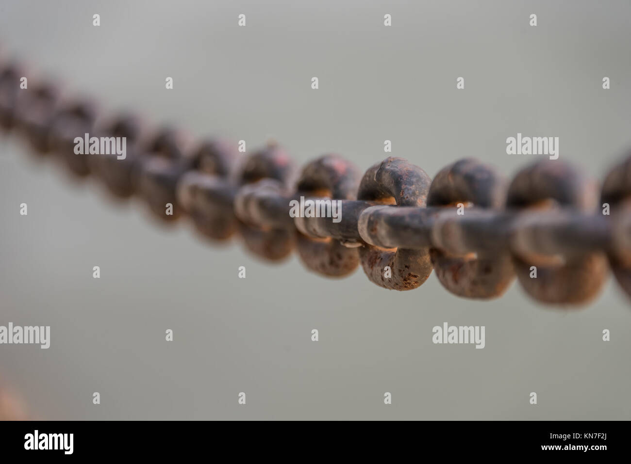 Close-Up Of Chain Railing against river. Stock Photo