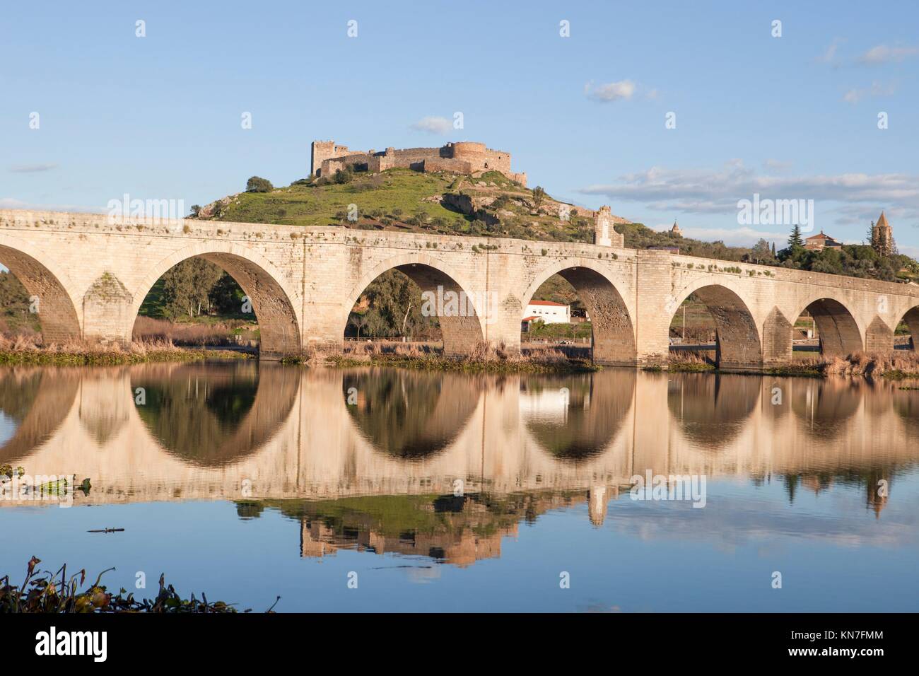Medellin old bridge and castle from Guadiana riverside, Spain. Stock Photo