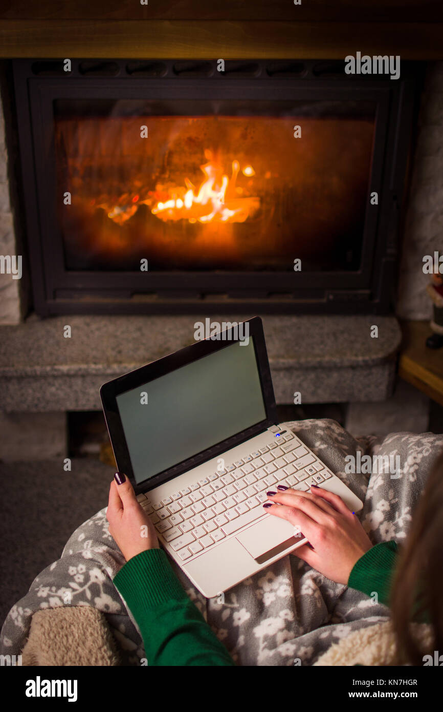 Woman Using Laptop By The Fireplace At Home Cozy Winter Lifestyle