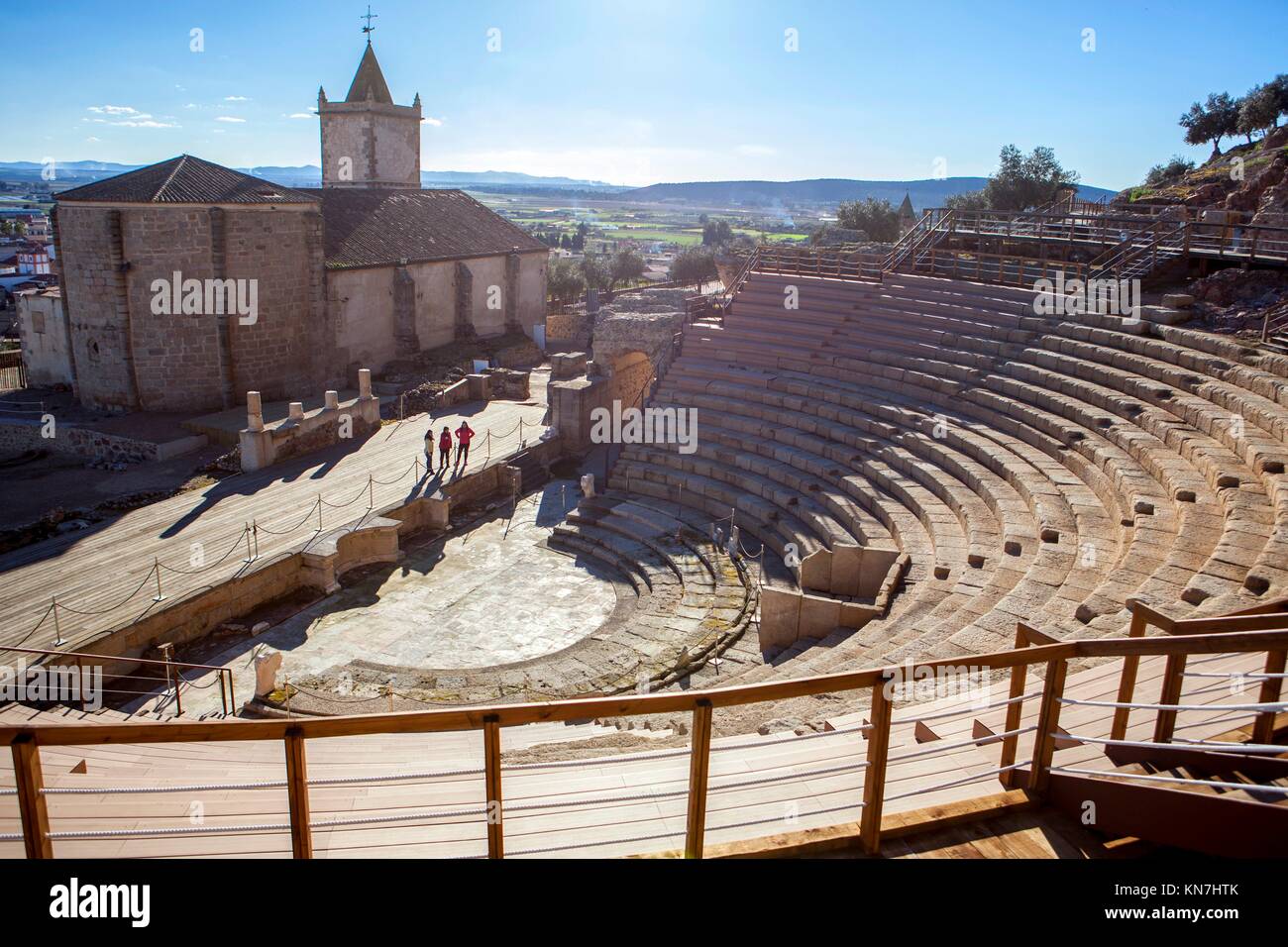Two people with tourist guide visiting the Roman theatre of Medellin, Spain. High view from grandstand to stage. Stock Photo